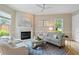 Cozy living room with fireplace, plush seating, and hardwood floors for comfortable gathering at 11945 Dancliff Trce, Alpharetta, GA 30009