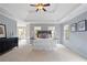 Bright main bedroom features a tray ceiling, plush carpeting, and large windows for plenty of natural light at 11945 Dancliff Trce, Alpharetta, GA 30009