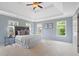 Spacious bedroom featuring a trey ceiling, plush carpeting, and abundant natural light at 11945 Dancliff Trce, Alpharetta, GA 30009