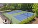 Aerial view of well-maintained community tennis courts surrounded by lush greenery at 11945 Dancliff Trce, Alpharetta, GA 30009