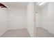 Bright walk-in closet with carpeted floor and ample wire shelving at 11945 Dancliff Trce, Alpharetta, GA 30009