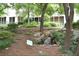 Natural backyard with rock waterfall, stone steps, and mature trees at 1323 Peachtree Ne Vw, Atlanta, GA 30319