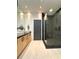 Beautiful bathroom with modern vanity, dual sinks, glass shower, and tiled floors at 1323 Peachtree Ne Vw, Atlanta, GA 30319