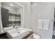 Modern bathroom with sleek square sink, large mirror and neutral striped shower curtain at 1323 Peachtree Ne Vw, Atlanta, GA 30319