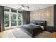 Modern bedroom featuring a large window with natural light and textured accent wall at 1323 Peachtree Ne Vw, Atlanta, GA 30319