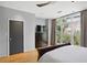 Bright bedroom featuring a large window, hardwood floors, and dark wood furnishings at 1323 Peachtree Ne Vw, Atlanta, GA 30319