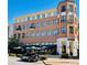 Four story brick building with balconies, black framed windows, and ground floor retail at 1323 Peachtree Ne Vw, Atlanta, GA 30319