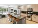 Modern kitchen featuring stainless steel appliances, island with seating, and ample counter space at 1323 Peachtree Ne Vw, Atlanta, GA 30319