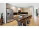 Kitchen featuring stainless steel appliances, island with seating, and wood floors at 1323 Peachtree Ne Vw, Atlanta, GA 30319