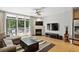 Bright living room with fireplace, balcony access, and open concept kitchen at 1323 Peachtree Ne Vw, Atlanta, GA 30319