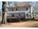 Back exterior view of home with deck and stairs descending to large backyard at 2031 Lakewood Cir, Grayson, GA 30017