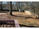 Backyard with storage shed, bordered by wooden fence and mature trees at 2031 Lakewood Cir, Grayson, GA 30017