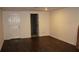 Unfurnished basement featuring dark hardwood floors, white trim and a door at 2031 Lakewood Cir, Grayson, GA 30017
