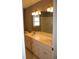 A bathroom featuring double sinks, marble countertops, white cabinetry, and tile flooring at 2031 Lakewood Cir, Grayson, GA 30017