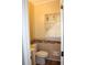 Compact half bathroom with decorative mirror, tile accents, and a window at 2031 Lakewood Cir, Grayson, GA 30017