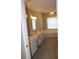 Bathroom featuring double sinks, white cabinetry, and a separate soaking tub at 2031 Lakewood Cir, Grayson, GA 30017