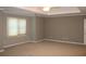 A spacious bedroom featuring neutral colored walls, beige carpeting, and an updated ceiling fan at 2031 Lakewood Cir, Grayson, GA 30017