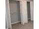 A wide-open closet featuring bi-fold doors, wire racks, and gray colored walls at 2031 Lakewood Cir, Grayson, GA 30017