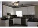 Well-equipped kitchen featuring stainless steel appliances, dark countertops, and white cabinetry at 2031 Lakewood Cir, Grayson, GA 30017