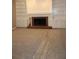 Spacious living room with fireplace, built-in bookcases, and protective carpet covering at 2031 Lakewood Cir, Grayson, GA 30017