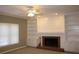Cozy living room featuring a brick fireplace, built-in shelving, and neutral carpet at 2031 Lakewood Cir, Grayson, GA 30017