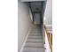 Carpeted stairway with wood handrail leads to the upper level of the home at 2031 Lakewood Cir, Grayson, GA 30017