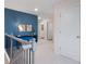 Bright hallway with blue accent wall, modern decor, and white trim throughout at 7 Camellia Dr, Fairburn, GA 30213