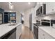 Updated kitchen with stainless appliances, bright countertops and nearby built-in banquette seating at 7 Camellia Dr, Fairburn, GA 30213