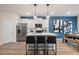 Bright kitchen with white cabinets, stainless steel appliances, island seating, and an adjacent dining area at 7 Camellia Dr, Fairburn, GA 30213
