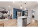 Spacious kitchen with stainless steel appliances, quartz counters, and an island overlooking the living area at 7 Camellia Dr, Fairburn, GA 30213