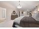 A spacious primary bedroom with neutral tones, plush carpet, and a decorative lighting fixture at 7 Camellia Dr, Fairburn, GA 30213