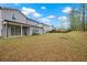 The property has a large grassy backyard with a covered patio at 730 Lanarck Way, Peachtree City, GA 30269