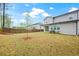 Wide backyard with lush grass, tree line, and privacy fence at 730 Lanarck Way, Peachtree City, GA 30269