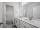 Bathroom featuring double sinks with a large mirror and modern fixtures at 730 Lanarck Way, Peachtree City, GA 30269