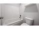 Clean bathroom featuring shower and tub combination and white fixtures at 730 Lanarck Way, Peachtree City, GA 30269