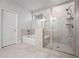 Updated bathroom has a glass shower enclosure and separate tub, combining style and functionality at 730 Lanarck Way, Peachtree City, GA 30269