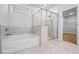 This bathroom includes a tiled shower and tub combination and a window, perfect for a refreshing experience at 730 Lanarck Way, Peachtree City, GA 30269