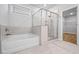 Bathroom features a bathtub and glass-enclosed shower at 730 Lanarck Way, Peachtree City, GA 30269
