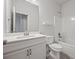 Modern bathroom featuring double sink vanity with sleek white countertop and tiled floors at 730 Lanarck Way, Peachtree City, GA 30269