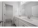Bathroom featuring double sinks, quartz countertop, gray tile floor and large mirror at 730 Lanarck Way, Peachtree City, GA 30269