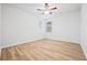 Bright, airy bedroom with wood floors, ceiling fan, and two windows at 730 Lanarck Way, Peachtree City, GA 30269
