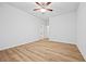 Spacious bedroom featuring wood-look flooring and a ceiling fan with an adjacent bathroom at 730 Lanarck Way, Peachtree City, GA 30269