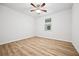 Cozy bedroom featuring wood-look floors, a ceiling fan, and a window providing natural light at 730 Lanarck Way, Peachtree City, GA 30269