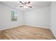 Bedroom with wood flooring, ceiling fan, and a window at 730 Lanarck Way, Peachtree City, GA 30269
