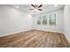 Bright bedroom with wood floors, ceiling fan, recessed lighting, and large windows at 730 Lanarck Way, Peachtree City, GA 30269