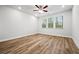 A bright bedroom includes a ceiling fan and several windows that flood the room with natural light at 730 Lanarck Way, Peachtree City, GA 30269
