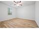 Bright bedroom featuring wood-look flooring, ceiling fan, and natural light from window at 730 Lanarck Way, Peachtree City, GA 30269