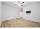 A bright bedroom with wood flooring, a ceiling fan and a wall mounted TV at 730 Lanarck Way, Peachtree City, GA 30269