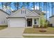 Charming single-Gathering home featuring a gray siding, well-manicured lawn, and a two-car garage at 730 Lanarck Way, Peachtree City, GA 30269
