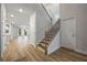 Spacious home foyer featuring hardwood floors, staircase, and entry to living spaces at 730 Lanarck Way, Peachtree City, GA 30269